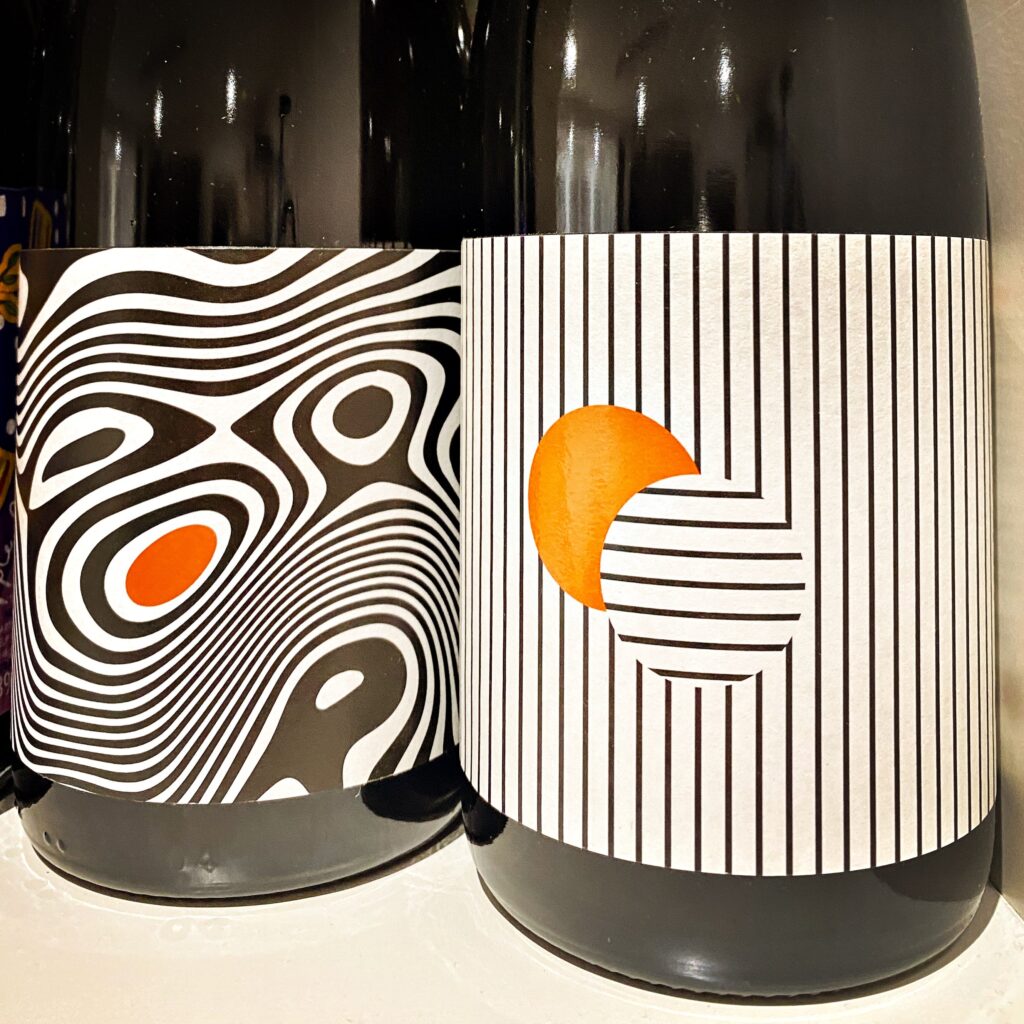 Image of two cider bottles showing the geometric label art