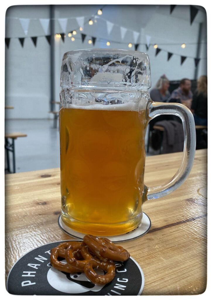 Image of a pint of beer and some prezel snacks