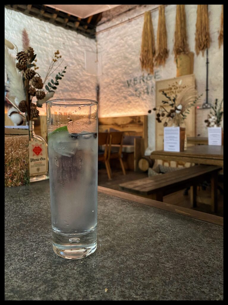 Image of a glass of gin and tonic on a table