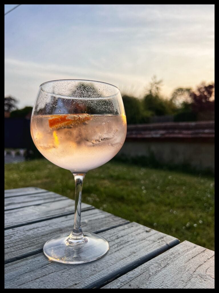 Image of a glass of gin and tonic on a table