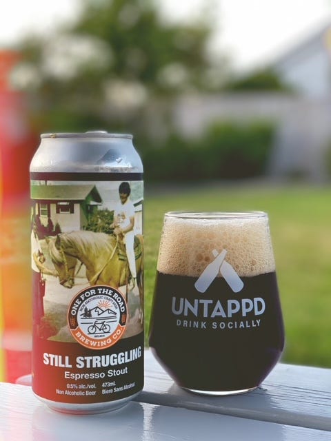 Image of a glass and can of non-alcoholic stout