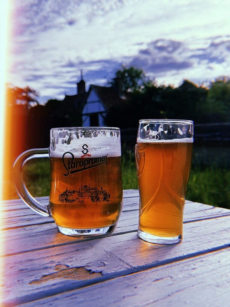 Image of two glasses of beer in a beer garden