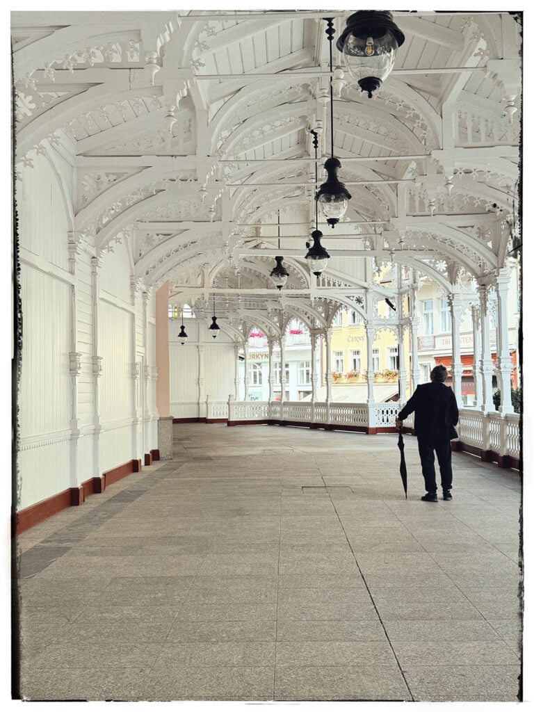 Image of a person walking through the Market Colonnade in Karlovy Vary